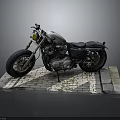 Classic Silver and Black Motorcycle with Large Tires on Brick Platform